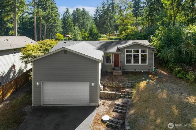 a front view of a house with a yard garage and outdoor seating