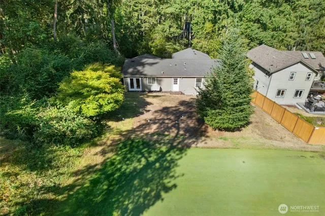 an aerial view of a house with swimming pool and garden