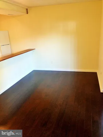 a view of a kitchen with wooden floor and a sink
