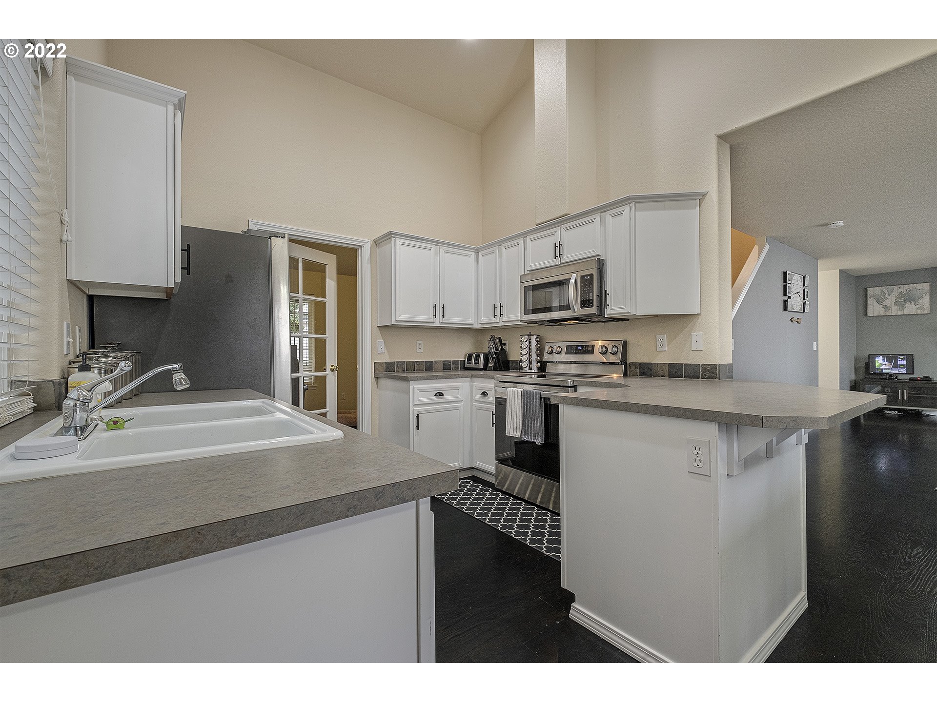 40348 Therese Street Sandy, OR 97055 - Photo 13 of 28 a kitchen with kitchen island white cabinets and refrigerator