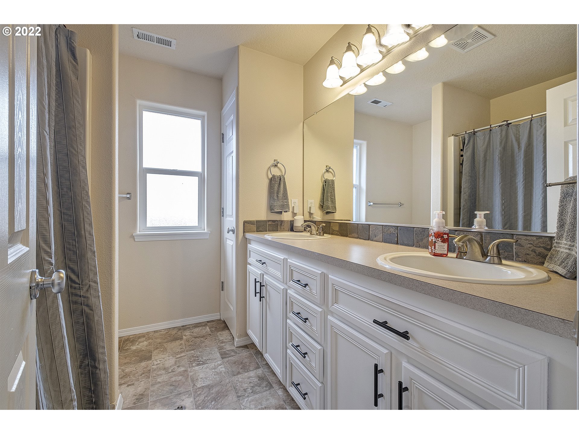 40348 Therese Street Sandy, OR 97055 - Photo 19 of 28 a bathroom with a double vanity sink and a mirror