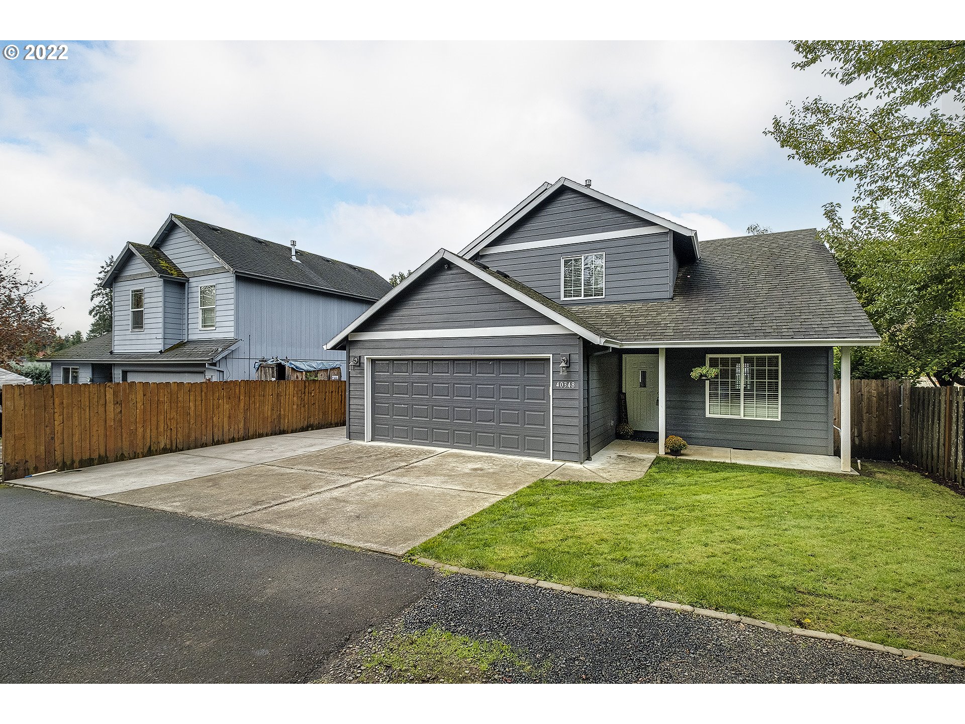 40348 Therese Street Sandy, OR 97055 - Photo 2 of 28 a front view of house with yard and trees in the background