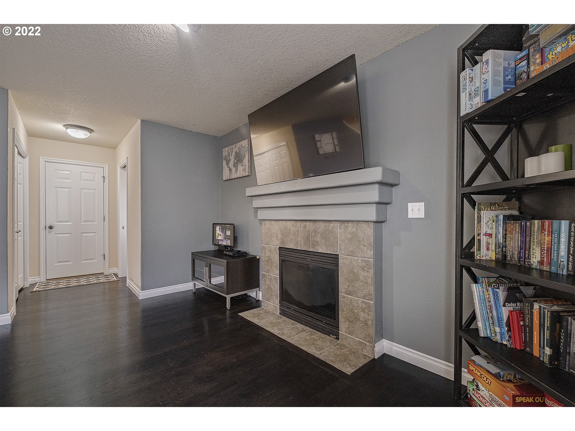 40348 Therese Street Sandy, OR 97055 - Photo 7 of 28 a living room with bookshelf and a fireplace