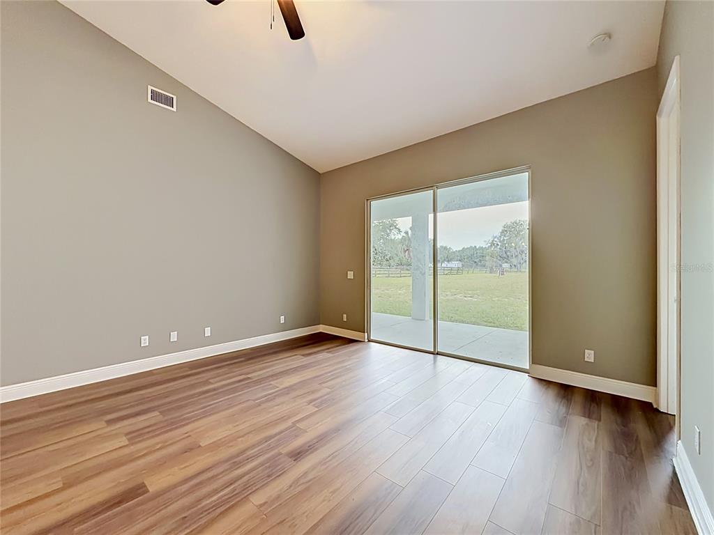 28549 Shirley Shores Road Tavares, FL 32778 - Photo 25 of 65 a view of an empty room with glass door