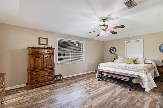 a bedroom with a bed and wooden floor