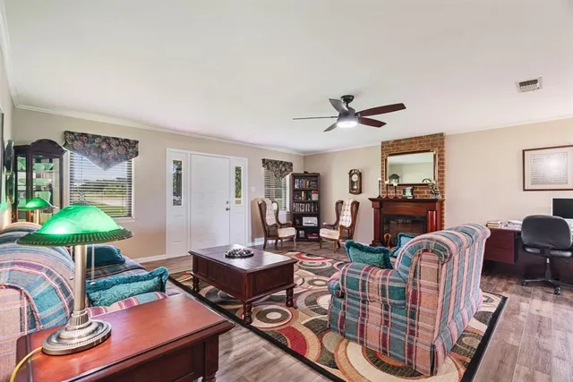 a living room with furniture a chandelier and a table