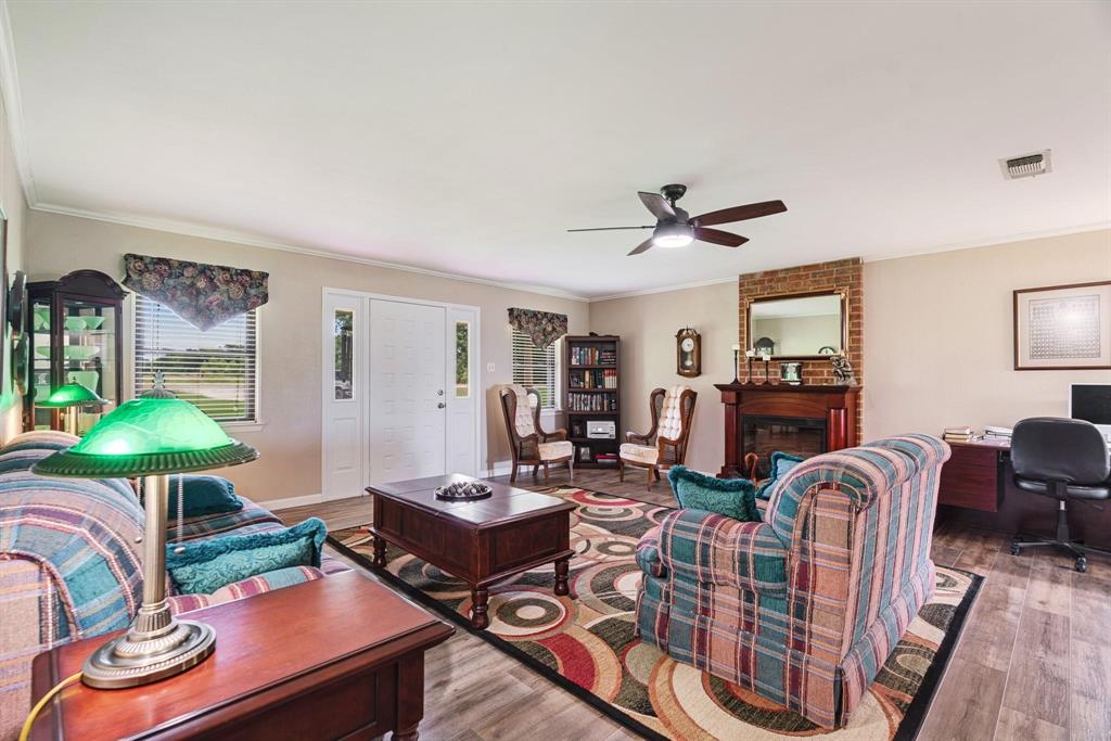 6951 Farm To Market 1499 Sumner, TX 75486 - Photo 2 of 26 a living room with furniture a chandelier and a table