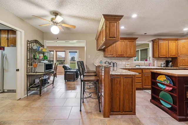 a kitchen with stainless steel appliances granite countertop a refrigerator and stove