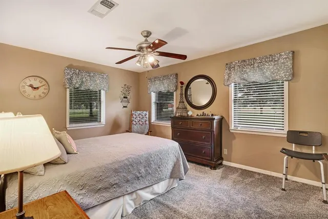 a bedroom with a bed mirror and a window
