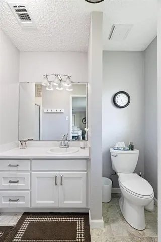 a bathroom with a sink a toilet and mirror