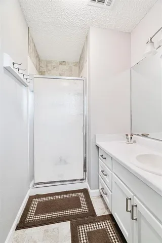 a bathroom with a sink a mirror and a shower