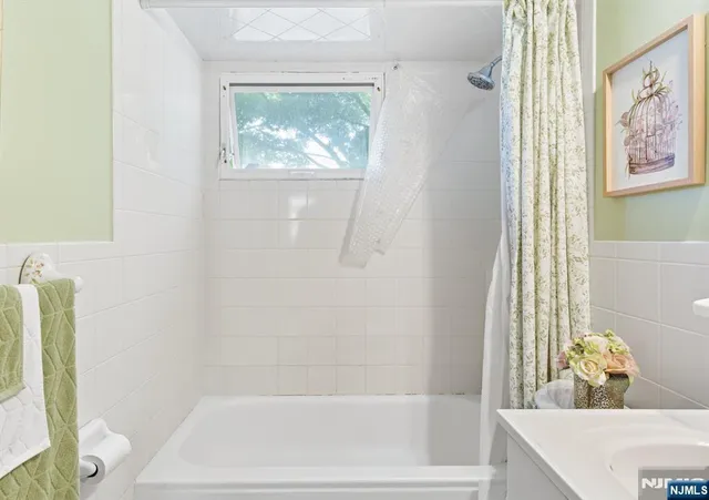 a bathroom with a bathtub and shower