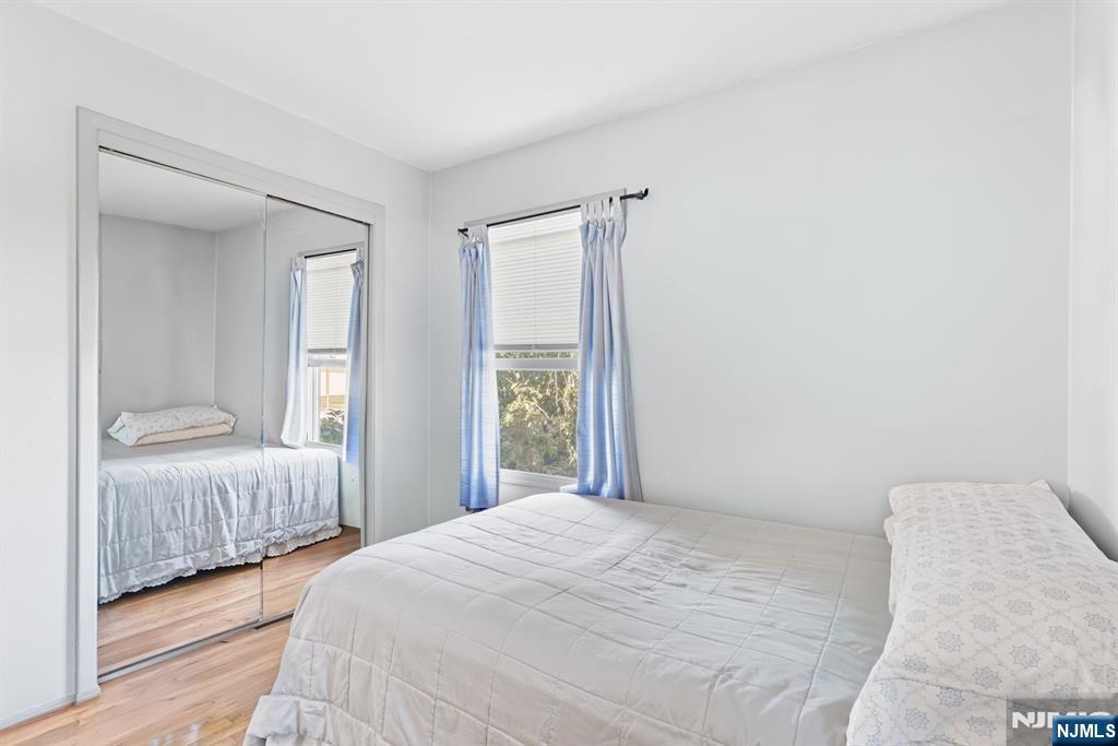 8 Lynn Boulevard Hazlet, NJ 07730 - Photo 18 of 25 a bedroom with a bed and wooden floor