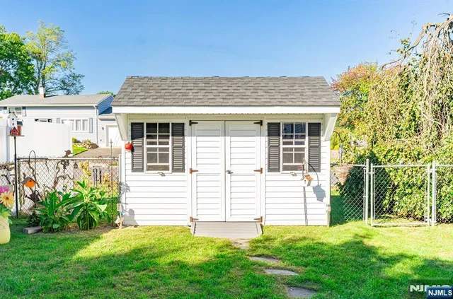 a view of a house with a yard and sitting area