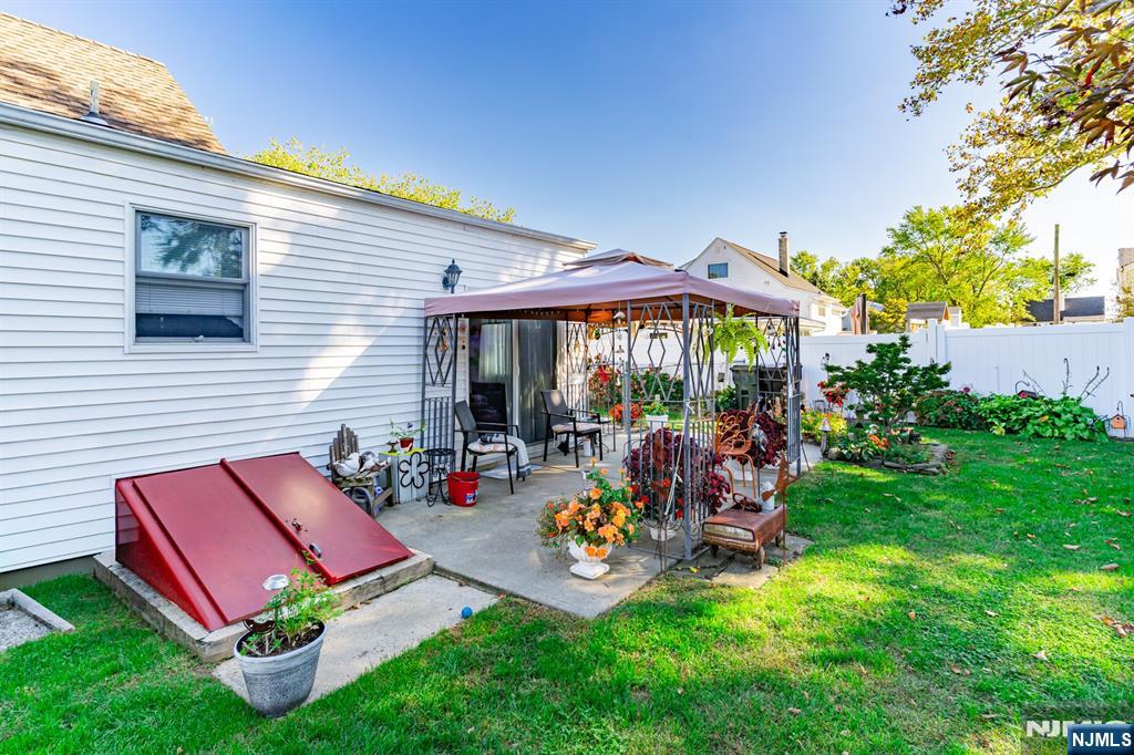 8 Lynn Boulevard Hazlet, NJ 07730 - Photo 22 of 25 a view of a chairs and table in backyard of the house