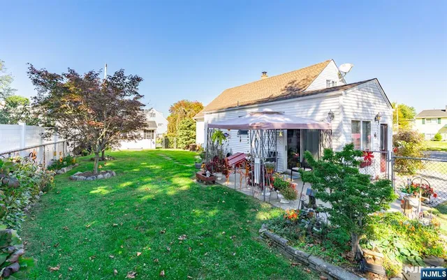 a view of a house with a backyard and a patio