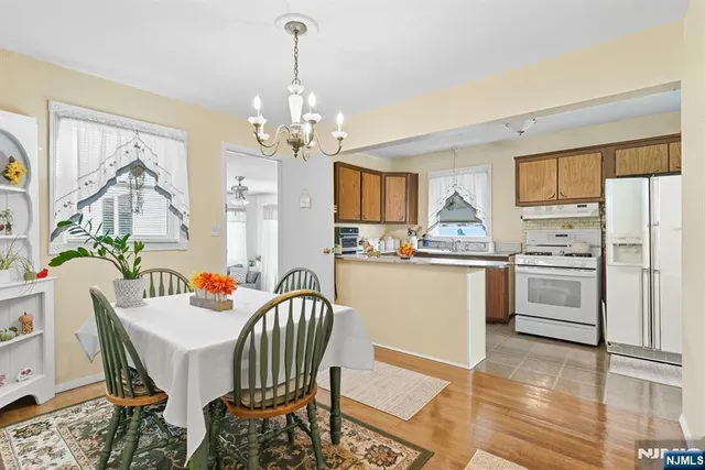 a kitchen with stainless steel appliances a dining table chairs and granite counter tops