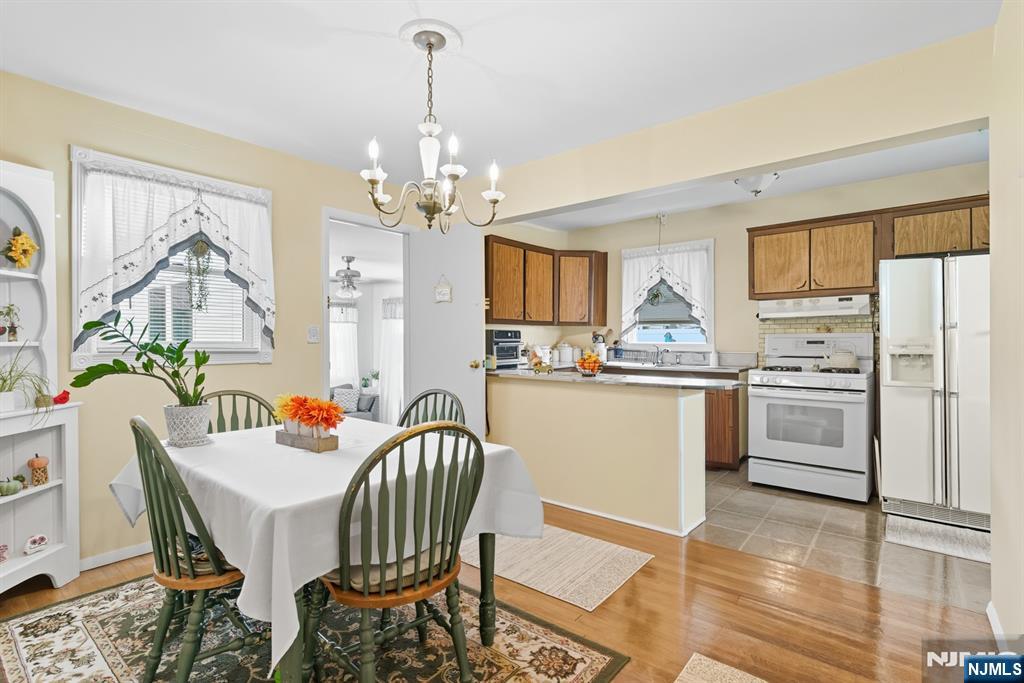 8 Lynn Boulevard Hazlet, NJ 07730 - Photo 8 of 25 a kitchen with stainless steel appliances a dining table chairs and granite counter tops