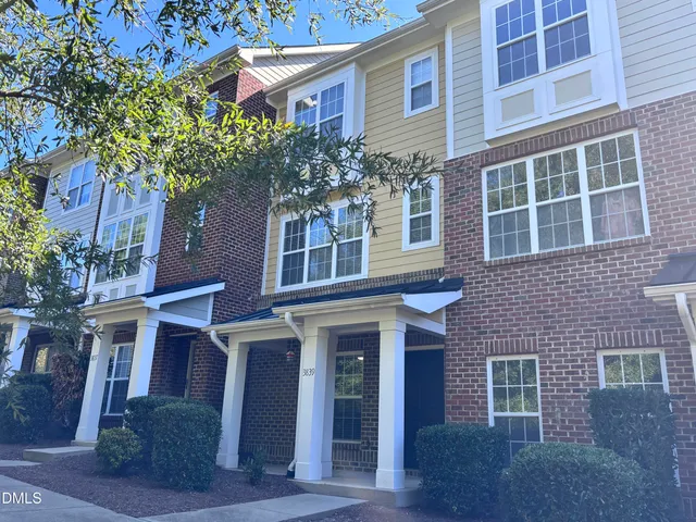 a kitchen with wooden cabinets a stove and a refrigerator