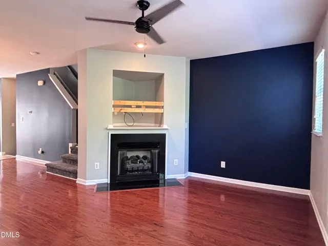 a view of a kitchen with a flat screen tv and wooden floor