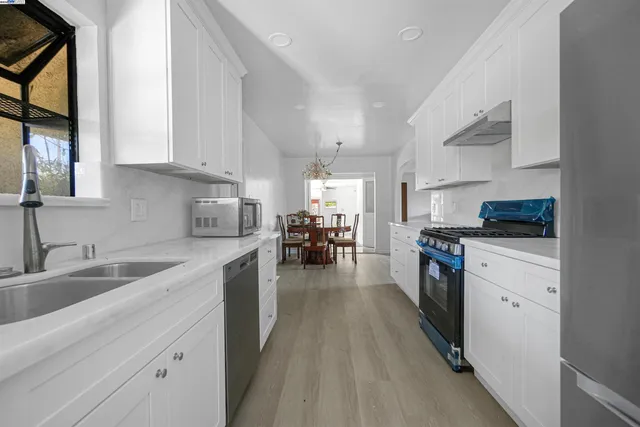 a dining room with furniture wooden floor and a chandelier