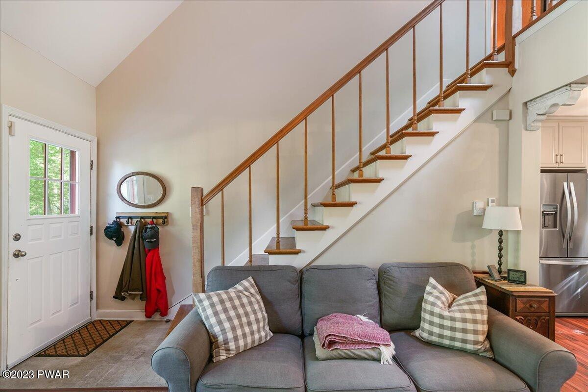 122 Ridge Drive Milford, PA 18337 - Photo 7 of 43 a living room with furniture stairs and a large window