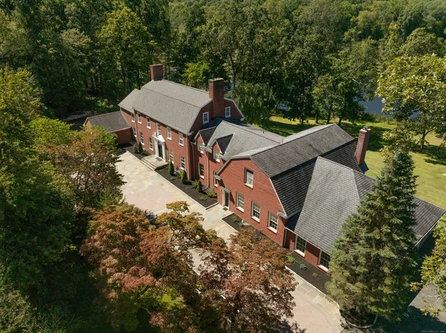 an aerial view of a house with a yard