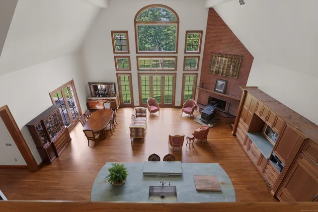 a living room with furniture fireplace and a large window