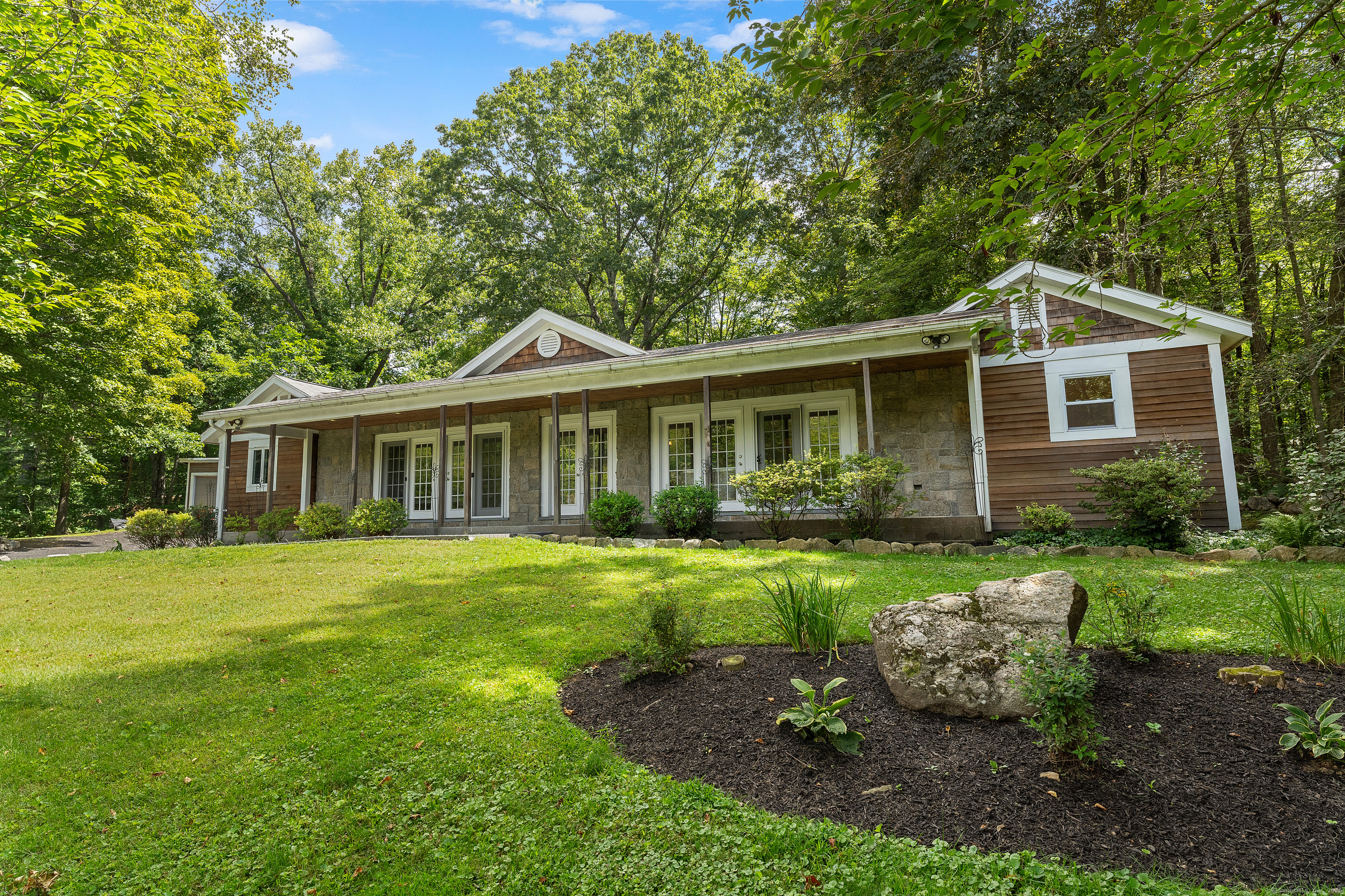 62 Big Bear Hill Road New Milford, CT 06776 - Photo 25 of 40 a front view of a house with a yard porch and wooden fence