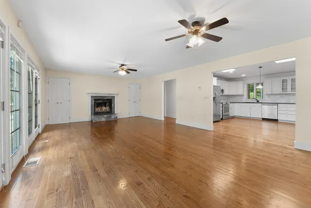 wooden floor in an empty room with a kitchen