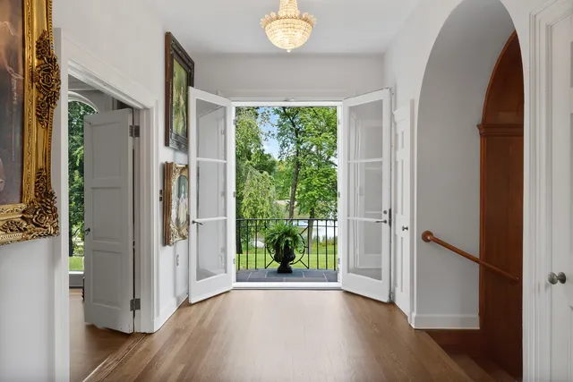 a view of an entryway with wooden floor and garden