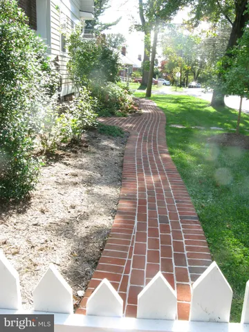 a view of a porch with wooden floor and a potted plant