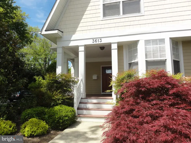 a vase with flowers sitting on a wooden floor