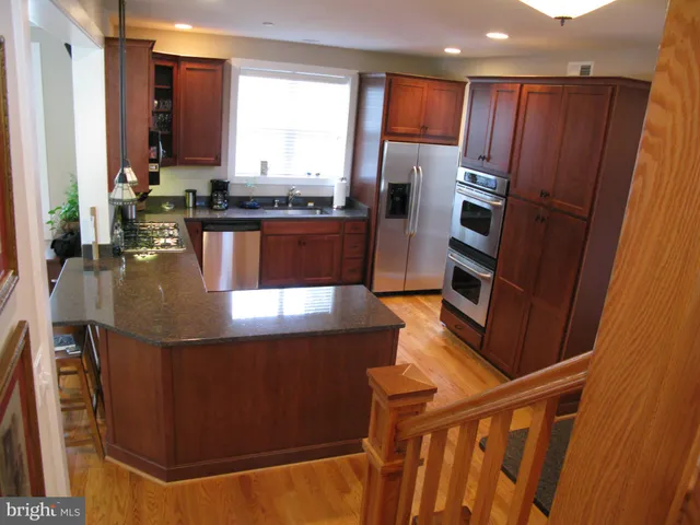 a living room with furniture a bookshelf and a window