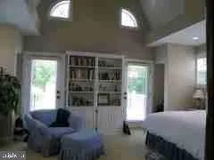 a bedroom with a bed and a couch