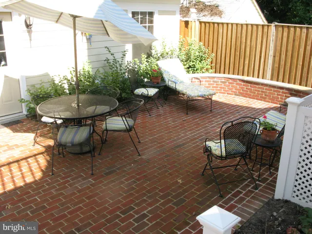 a view of a chairs and table in the patio