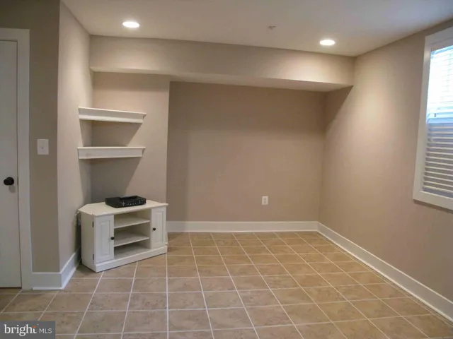 a bathroom with a granite countertop shower and a toilet