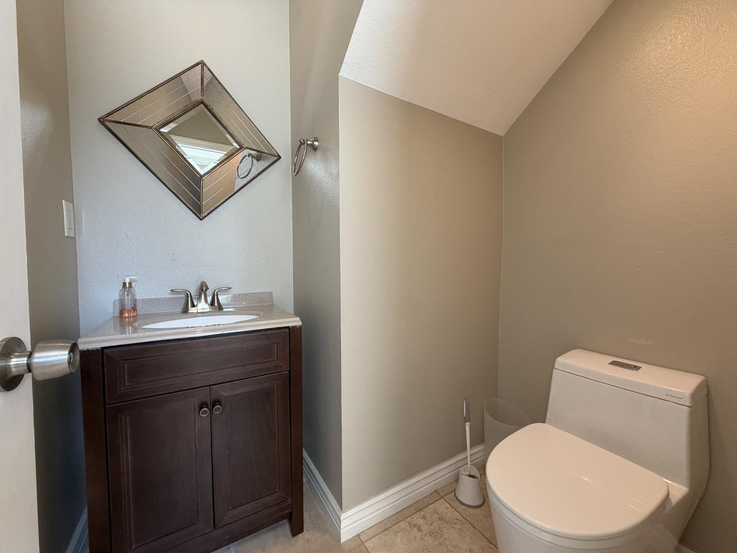 7272 East Gainey Ranch Road, Unit 19 Scottsdale, AZ 85258 - Photo 7 of 13 a bathroom with a toilet a sink and mirror