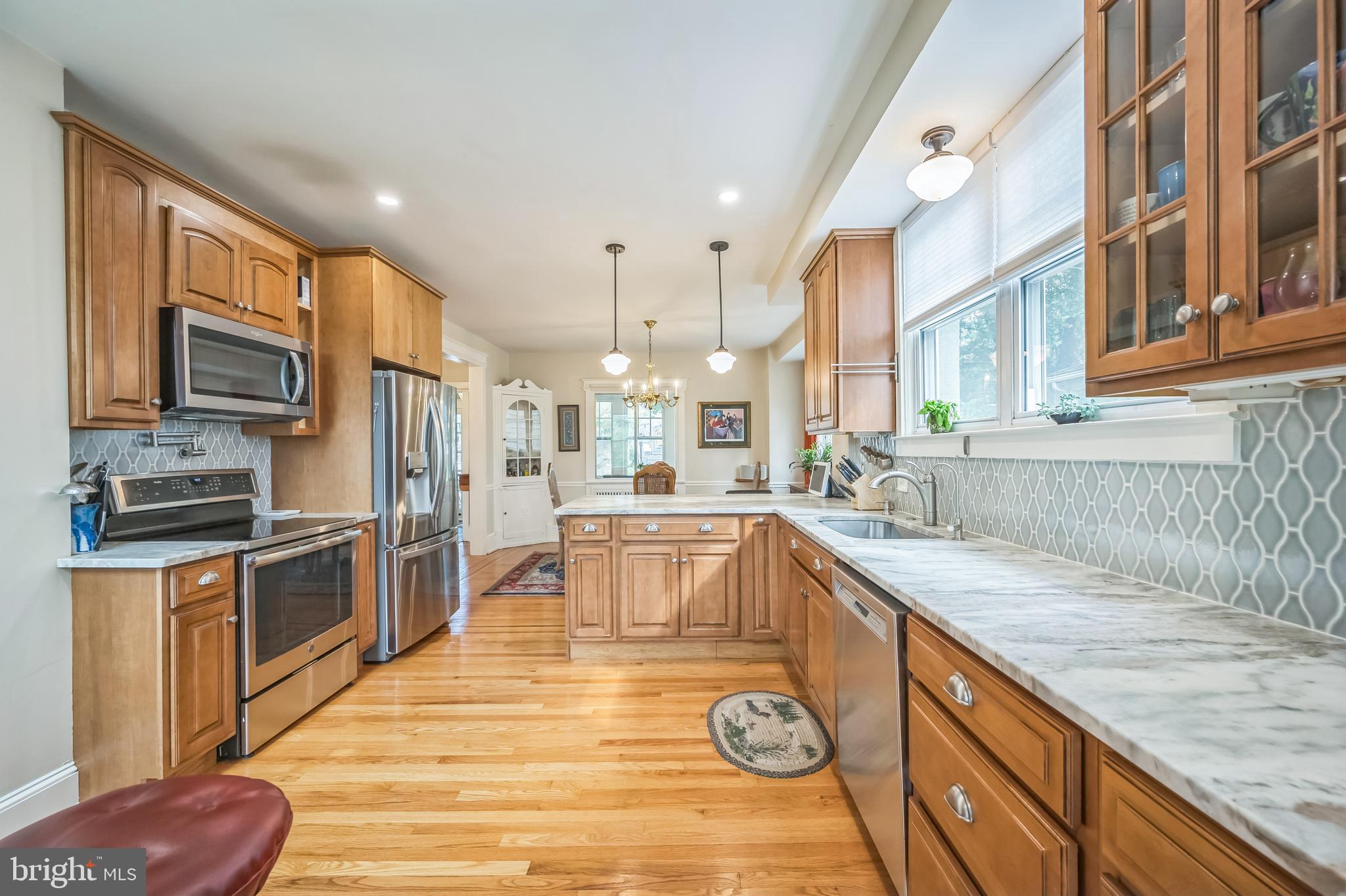 35 Harvard Road Audubon, NJ 08106 - Photo 14 of 36 a kitchen with a sink stove and wooden cabinets