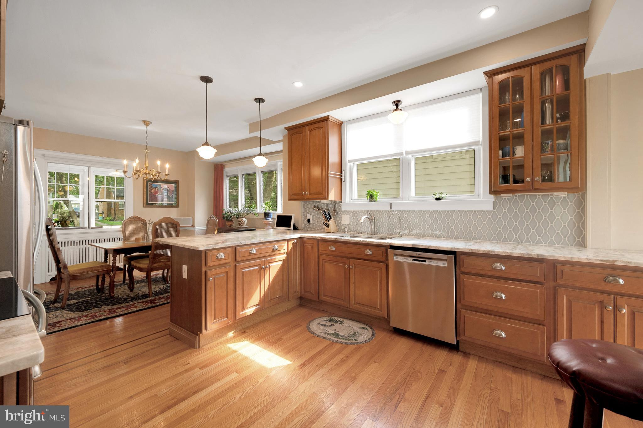 35 Harvard Road Audubon, NJ 08106 - Photo 15 of 36 a large kitchen with lots of counter space dining table and stainless steel appliances