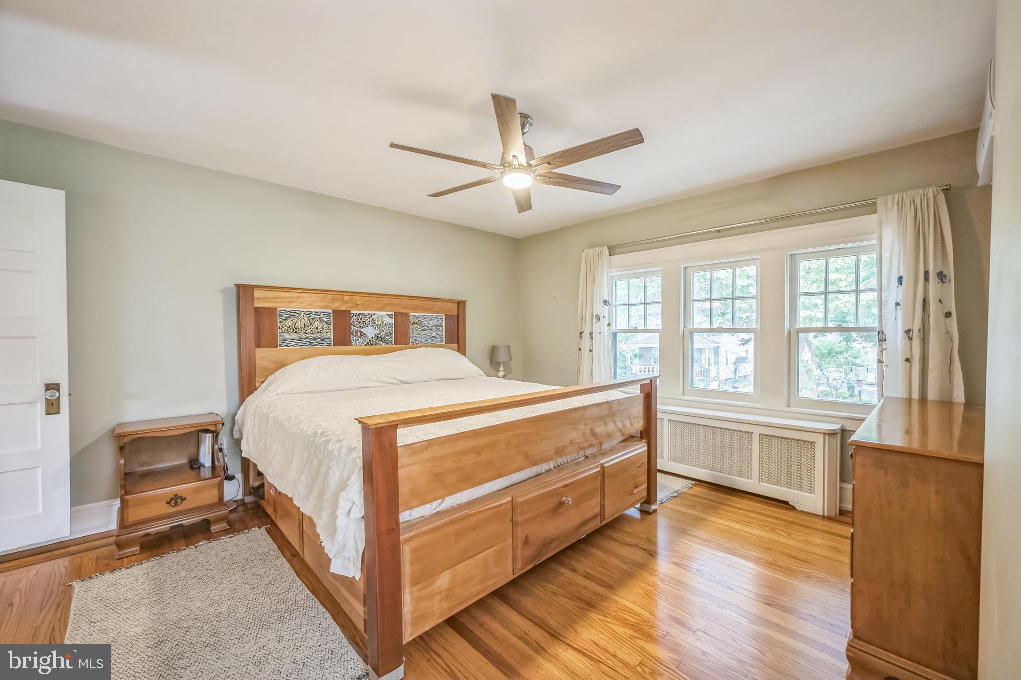 35 Harvard Road Audubon, NJ 08106 - Photo 18 of 36 a spacious bedroom with a bed and a large window with wooden floor