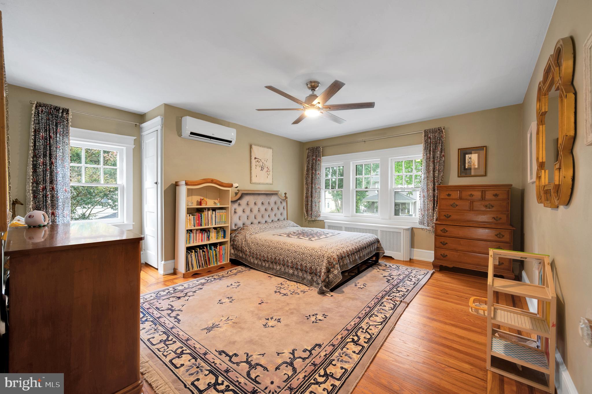 35 Harvard Road Audubon, NJ 08106 - Photo 21 of 36 a spacious bedroom with a large bed a chandelier and windows