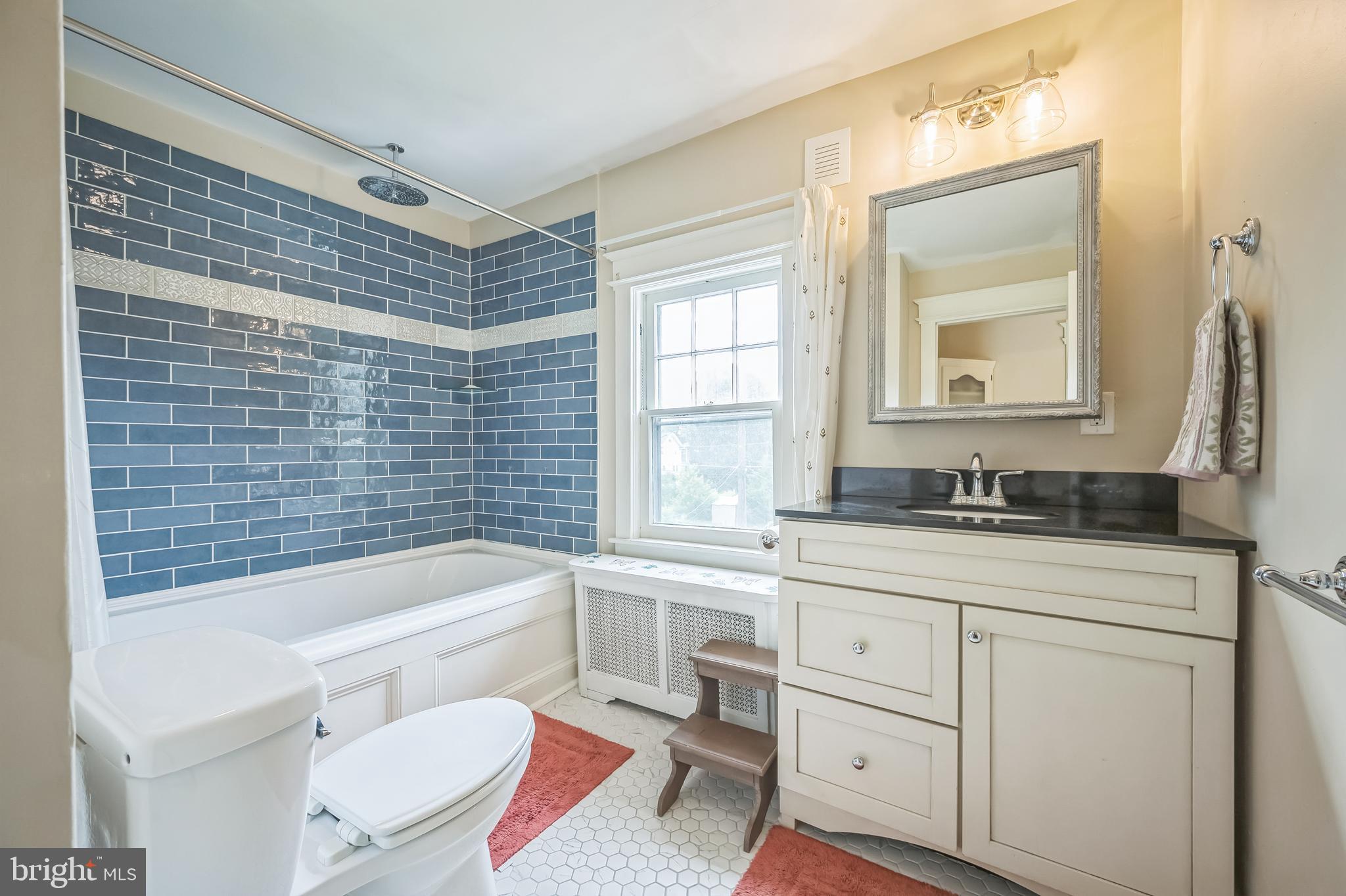 35 Harvard Road Audubon, NJ 08106 - Photo 24 of 36 a bathroom with a granite countertop toilet a sink a mirror a bathtub and shower
