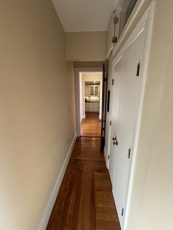 11 Revere Street, Unit 6 Boston, MA 02130 - Photo 18 of 32 a view of a hallway with wooden floor and a bathroom