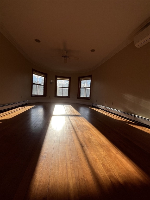 11 Revere Street, Unit 6 Boston, MA 02130 - Photo 19 of 32 a view of an empty room with wooden floor and windows