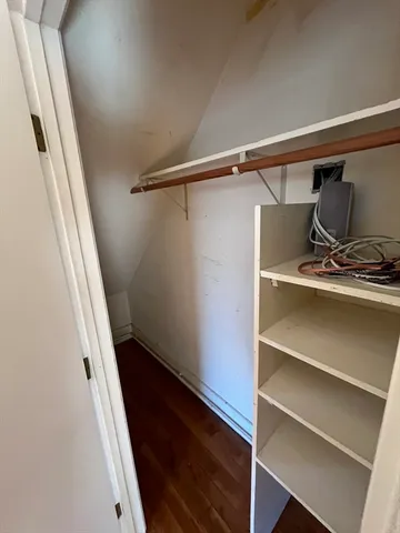 a view of walk in closet with empty racks