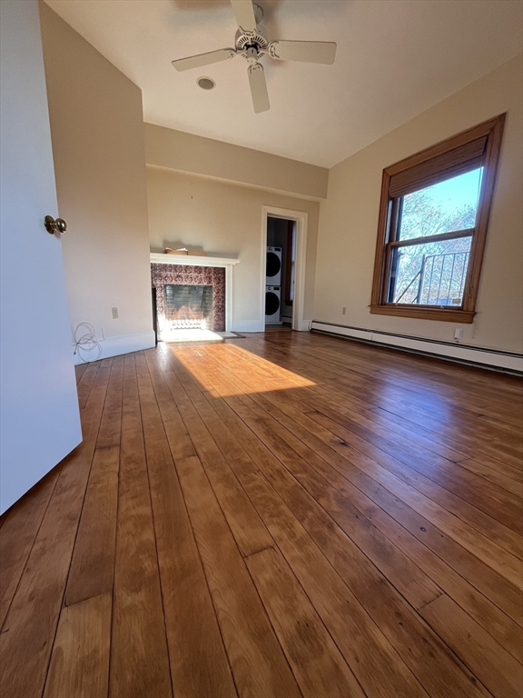 11 Revere Street, Unit 6 Boston, MA 02130 - Photo 26 of 32 a view of an empty room with a window and wooden floor