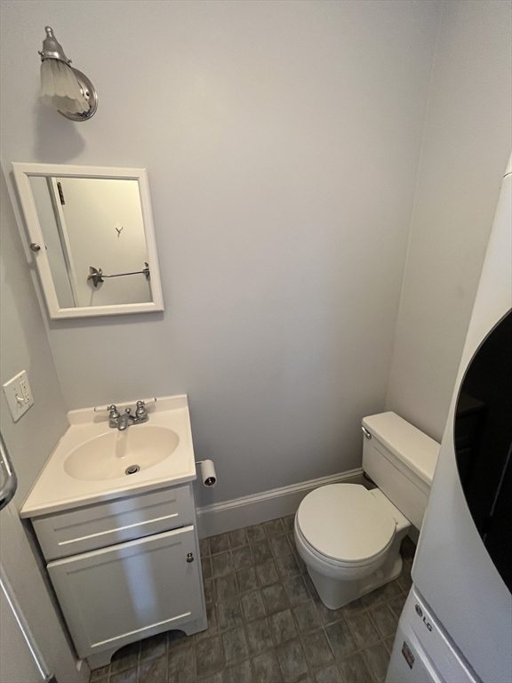 11 Revere Street, Unit 6 Boston, MA 02130 - Photo 28 of 32 a bathroom with a toilet a sink and mirror