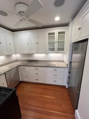 a kitchen with a refrigerator a sink and cabinets