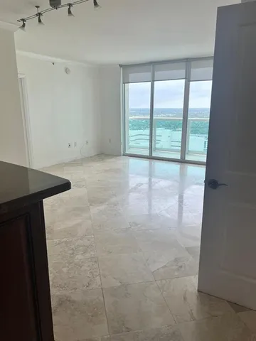 a kitchen with stainless steel appliances granite countertop a refrigerator a stove a sink and dishwasher